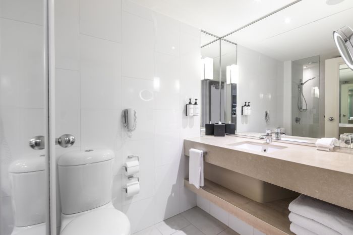 Classic guest room bathroom with luxury bulk amenities